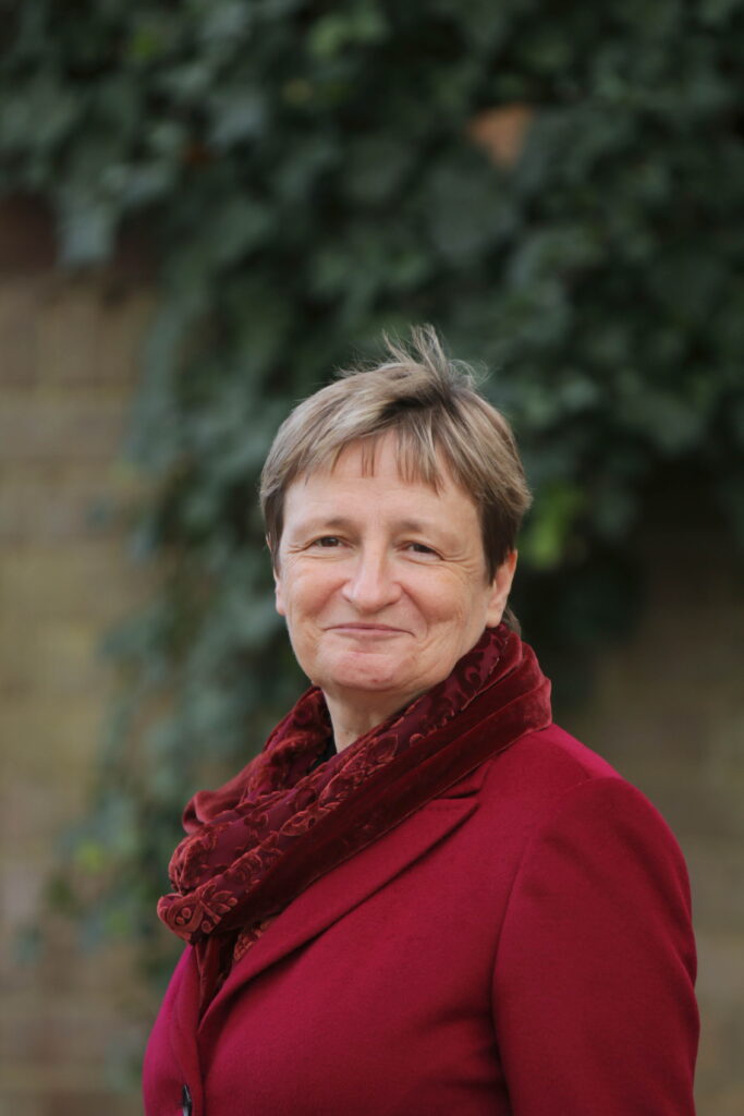 Annabel in red coat with red scarf smiling