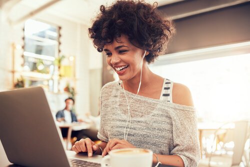 Freelancer working remotely on a laptop in a coffee shop