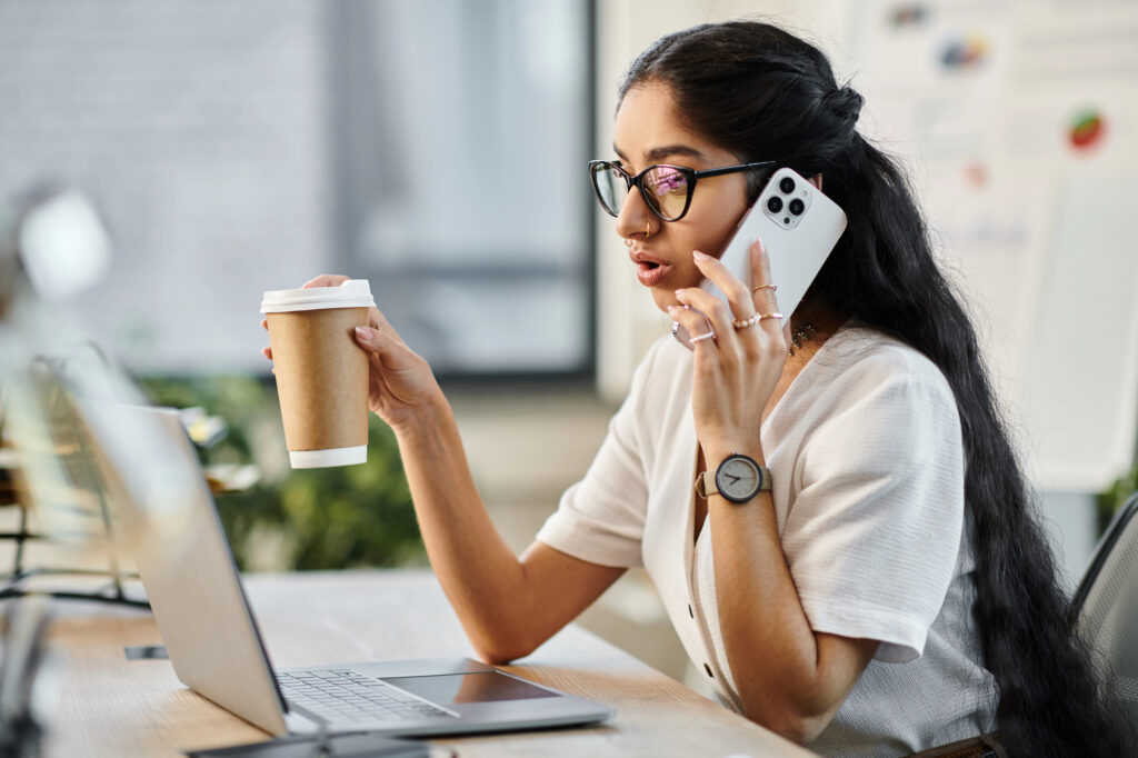 Freelancer using a personal mobile phone and laptop for client work