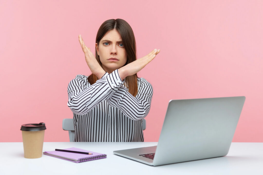 Freelancer at her laptop signalling stop